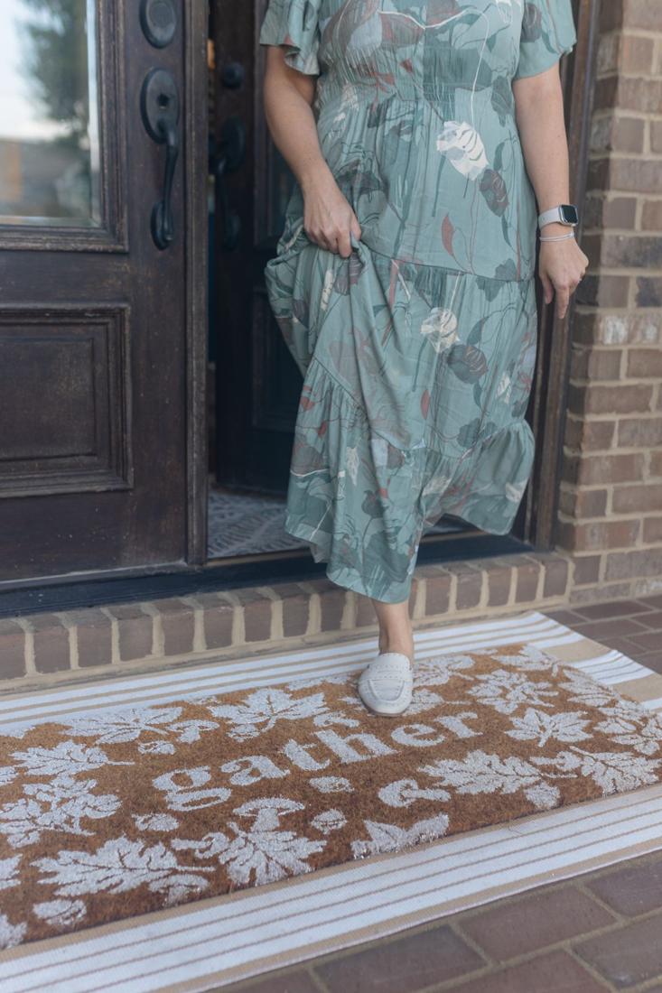Standing at the front door of a brick home